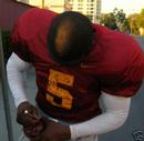 _reggiebushjr_com_img_reggie-bush-poster_RBsigning_MiniUSCHelmet.jpg